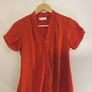 Calvin Klein burnt orange blouse size small, capped princess sleeves